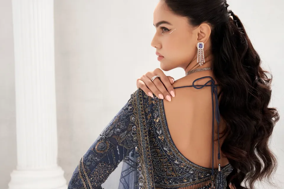 Back view in navy with long waves of hair and a diamond tassel earring