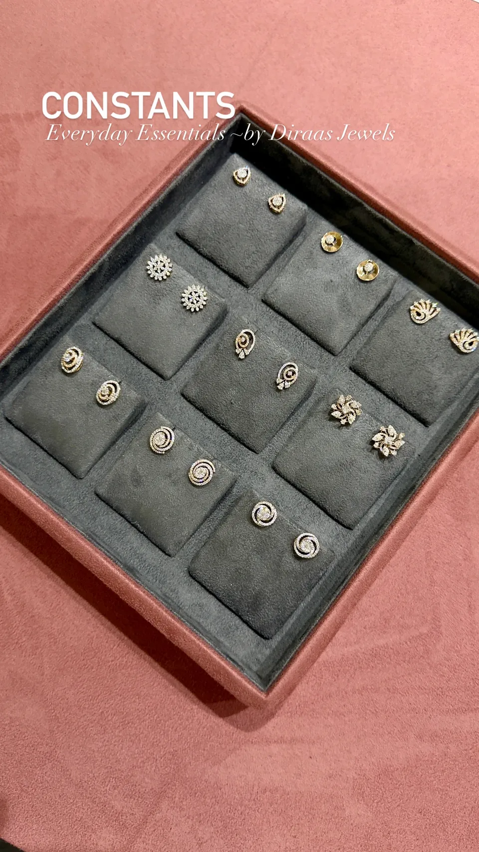 A tray of stud earrings in floral, swirl and halo designs